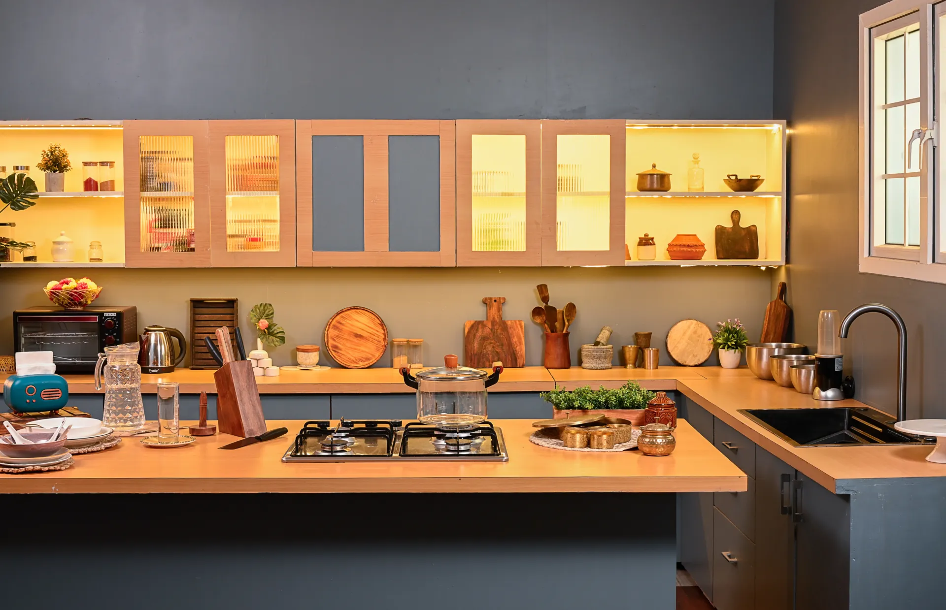 Premium grey and brown modular kitchen with cabinet lighting at 11 Minds Studio Kolkata